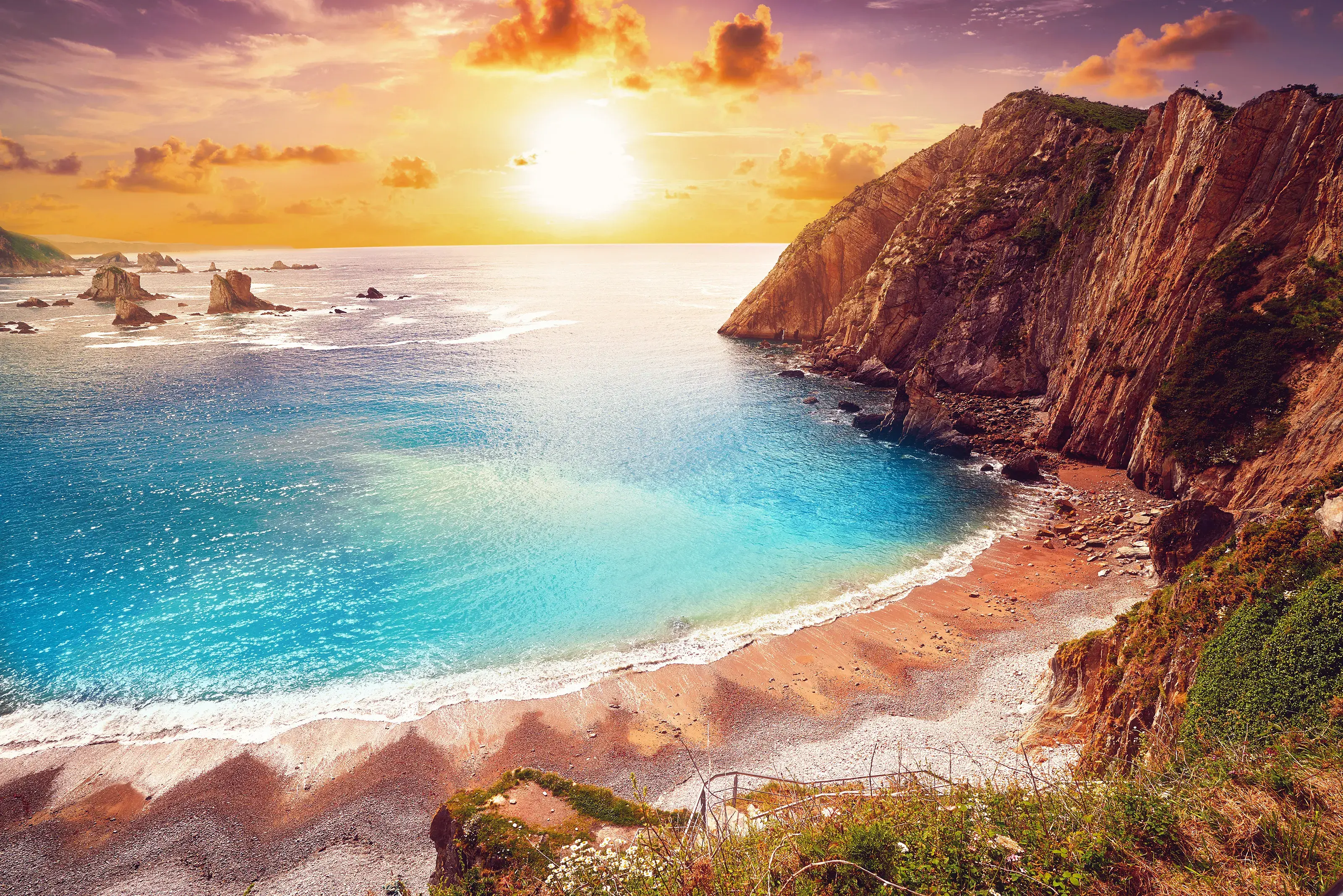 A breathtaking view of Playa del Silencio in Cudillero Asturias from Spain under a golden sunset.