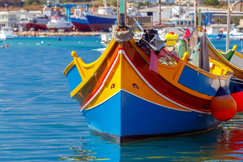 Malta. Marsaxlokk. Traditional fishing boats.. Traditional multicolored fishing boats Luzzi in the harbor Marsaxlokk. Malta.