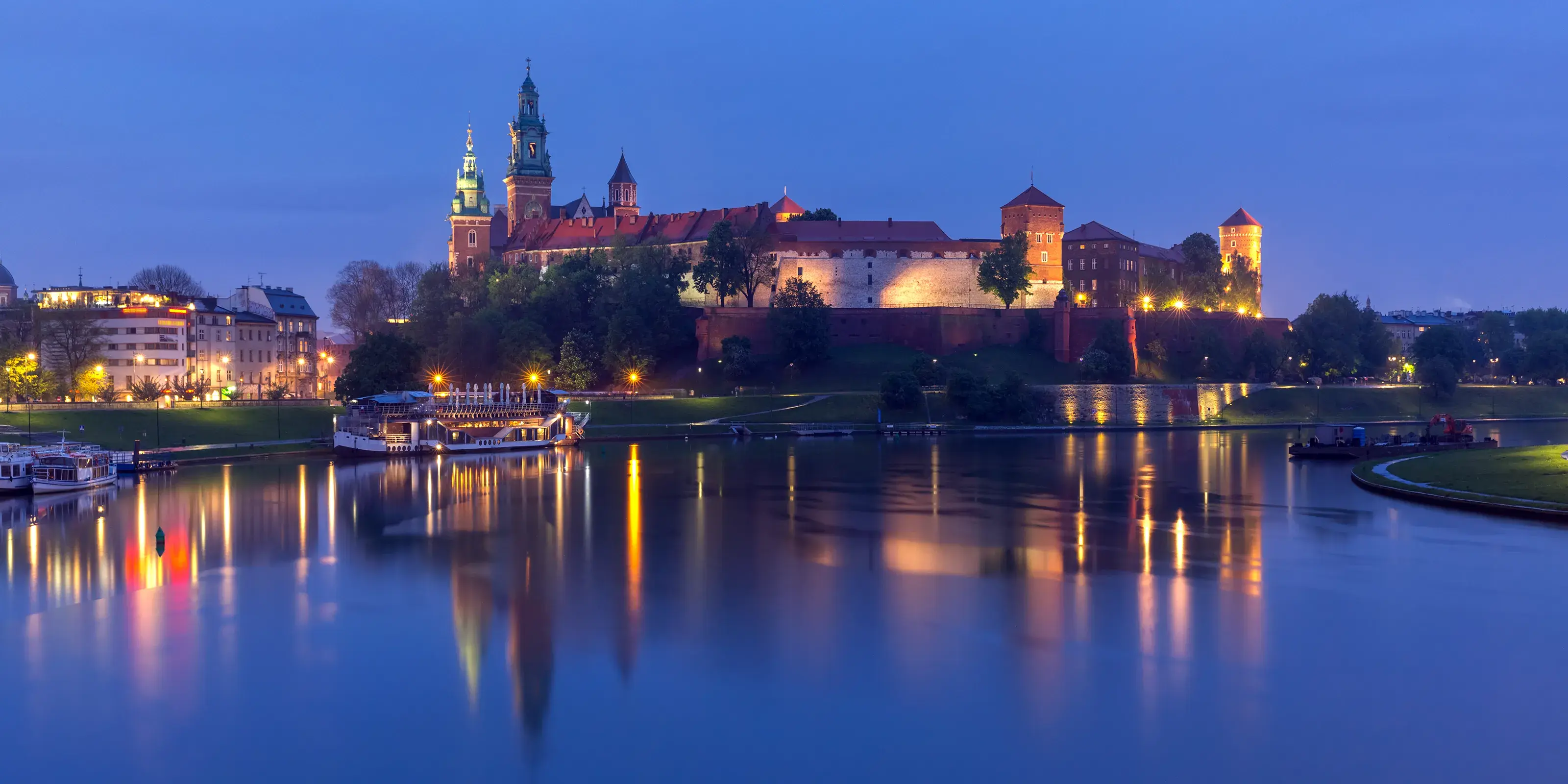Panorama of Wawel Castle on Wawel Hill with reflection in the river at night as seen from the Vistula, Krakow, Poland. Night Wawel castle, Wroclaw, Poland