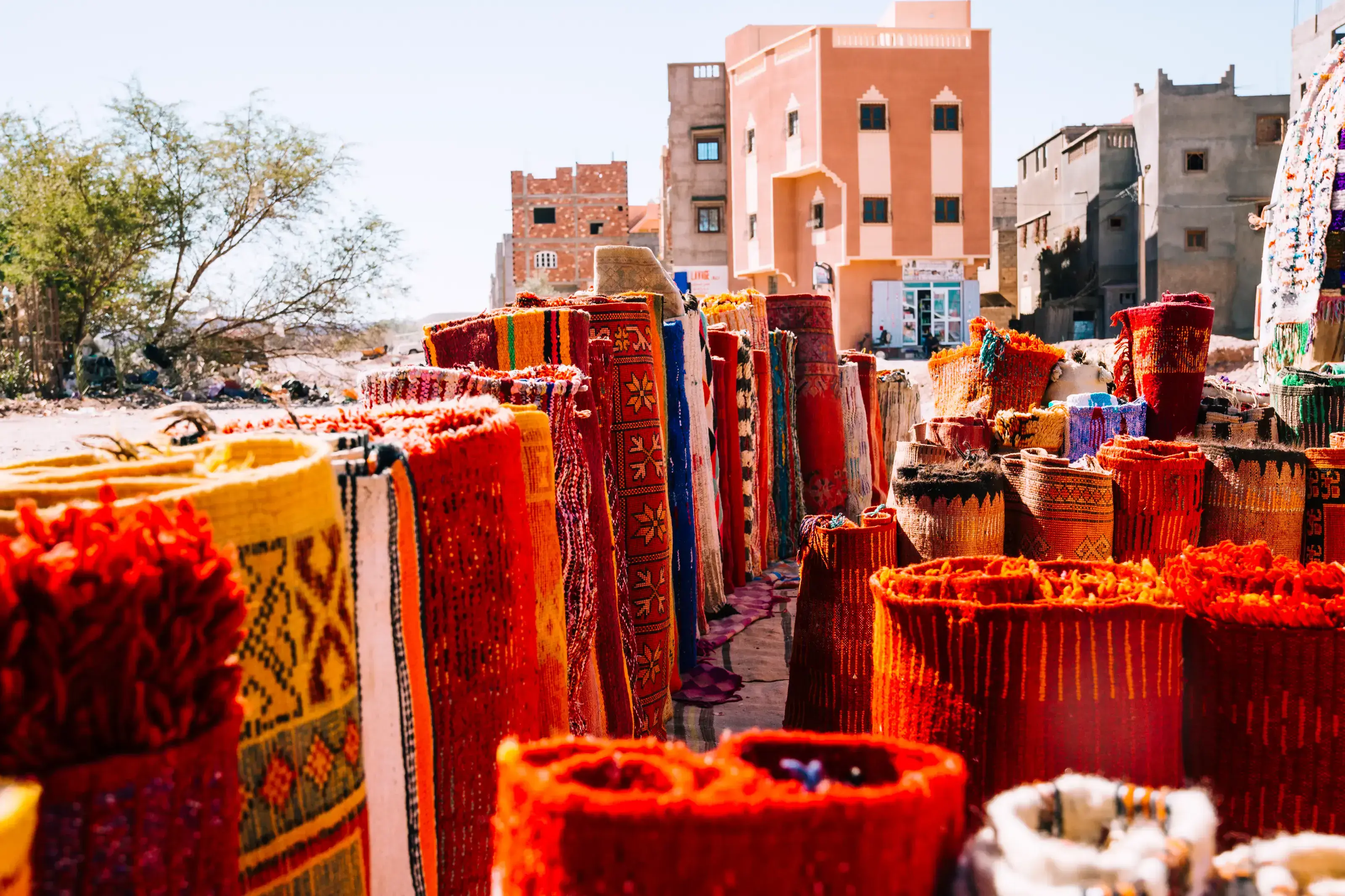 Rolled Berber rugs at an outdoor Marrakech market